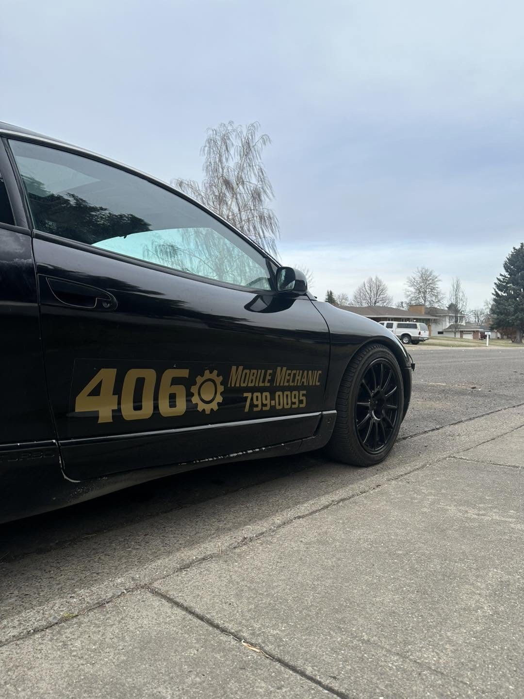 406 Mobile Mechanic vinyl lettering with 799-0095 on the side of Josh's black car